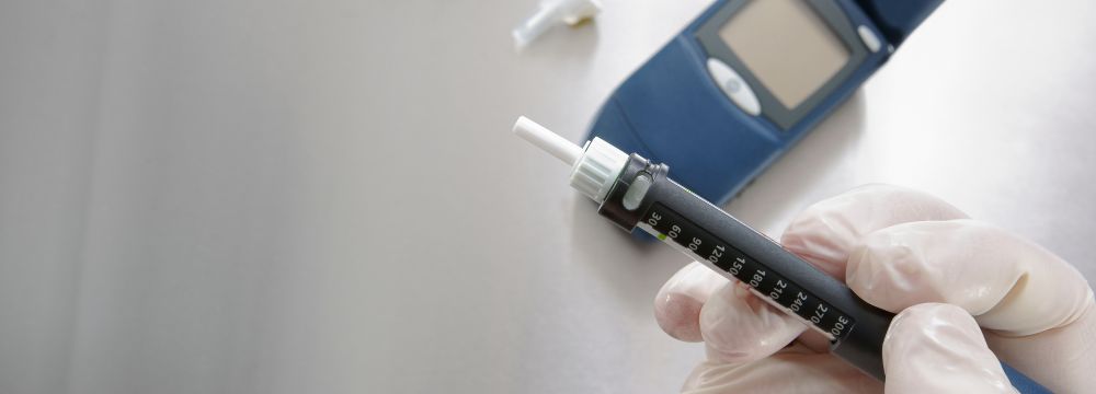 injection medication being held by person with white glove